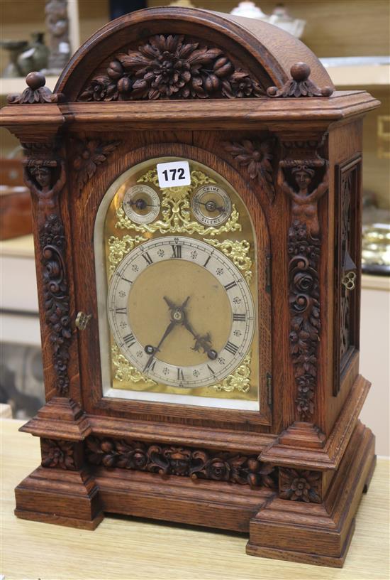 A large carved oak mantel clock height 50cm